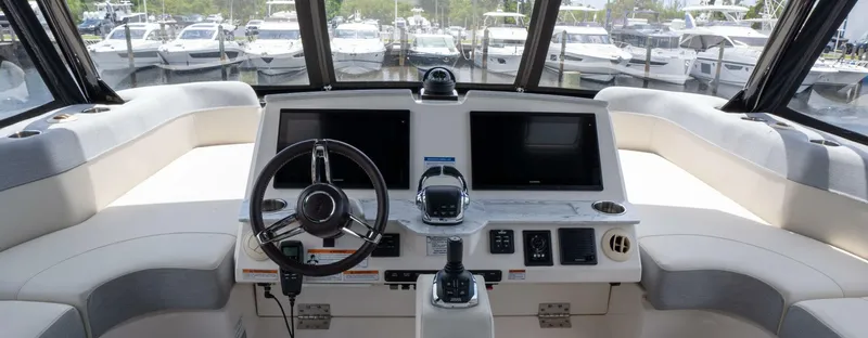 True North Yacht Photos Pics 2017 Tiara Yachts F53 Flybridge helm with dual screens and steering wheel.