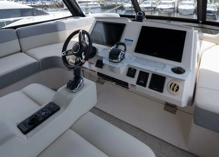 True North Yacht Photos Pics 2017 Tiara Yachts F53 Flybridge helm with modern controls and dual screens.