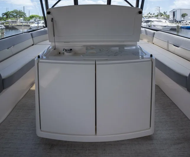 True North Yacht Photos Pics 2017 Tiara Yachts F53 Flybridge interior with seating and storage area.