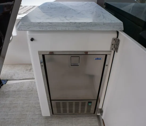 True North Yacht Photos Pics Stainless steel appliance on 2017 Tiara Yachts F53 Flybridge with marble countertop.