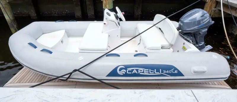 True North Yacht Photos Pics A Capelli 340 LE inflatable boat docked, featuring a Yamaha outboard motor.