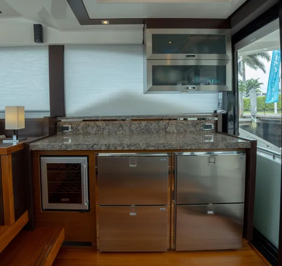 True North Yacht Photos Pics Luxurious kitchen area in 2017 Tiara Yachts F53 Flybridge with stainless steel appliances.