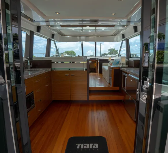 True North Yacht Photos Pics Interior of 2017 Tiara Yachts F53 Flybridge with modern kitchen and wooden flooring.