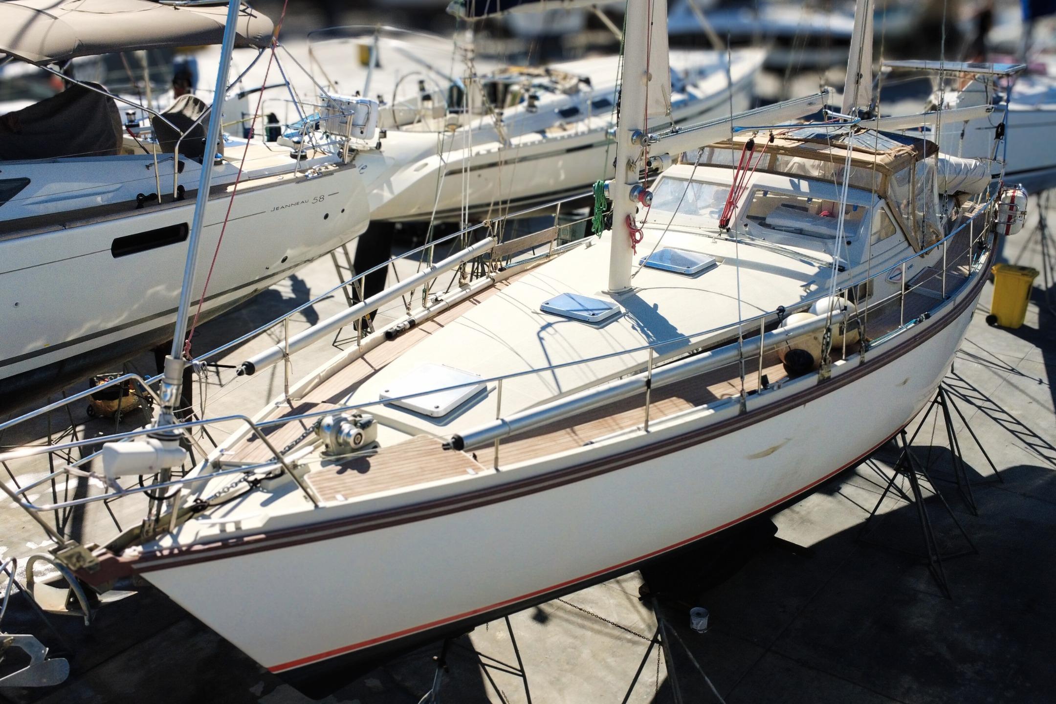 1995 Amel Santorin 46 sailboat on stands in a marina, ready for maintenance.