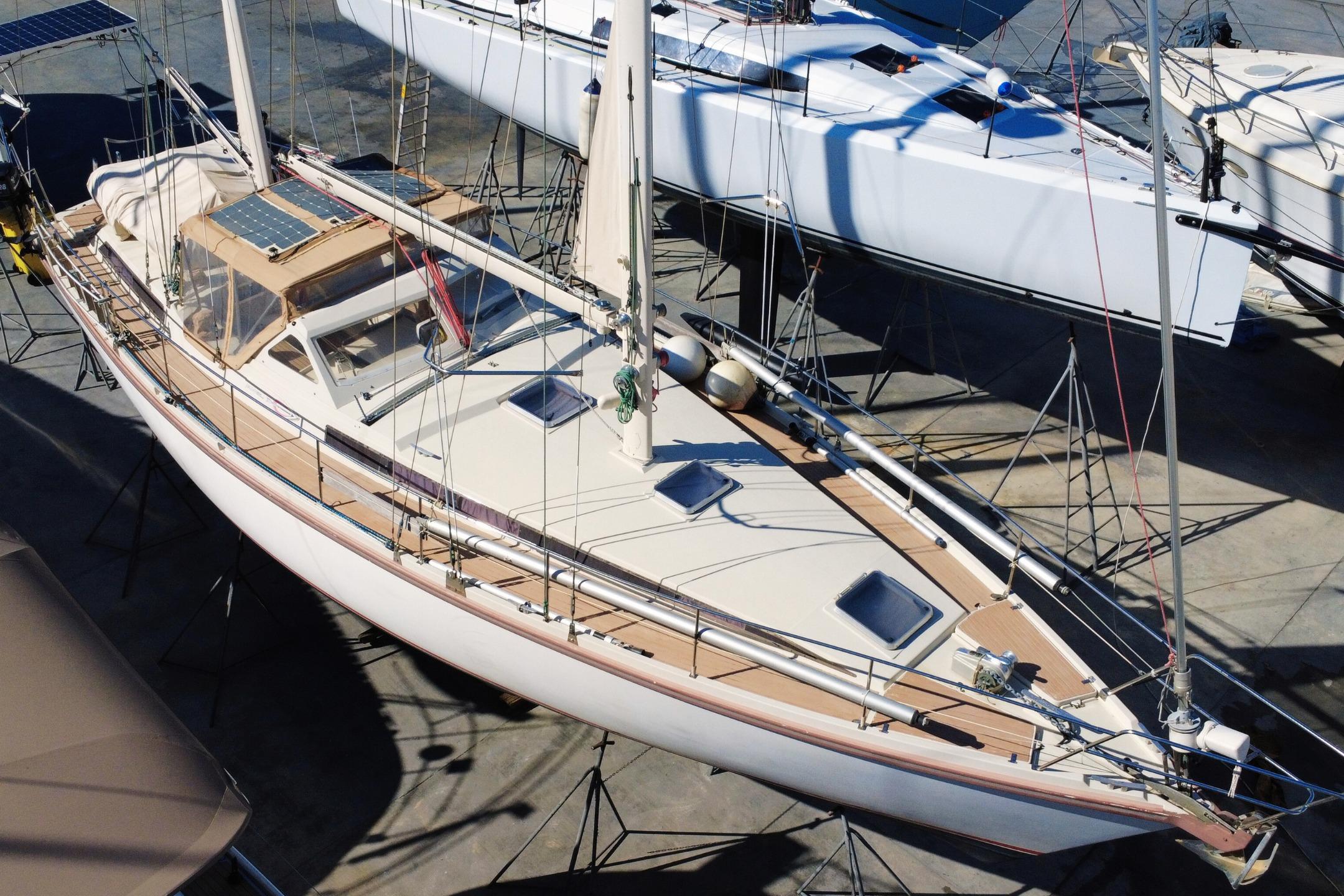 1995 Amel Santorin 46 sailboat on dry dock, showcasing deck and solar panels.