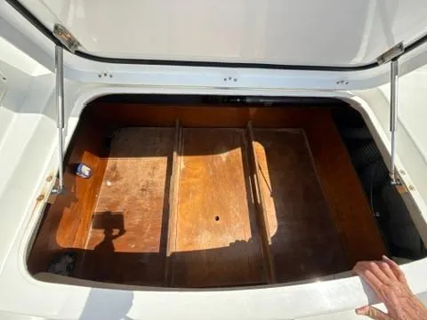 Ivana V Yacht Photos Pics Open storage compartment on a 2012 Lagoon 450 boat, featuring wooden interior.