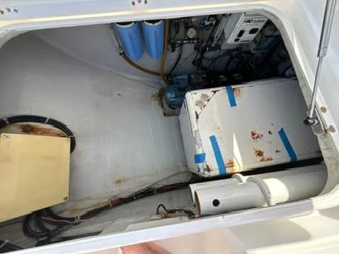 Ivana V Yacht Photos Pics Engine compartment of a 2012 Lagoon 450 catamaran, showing equipment and storage.