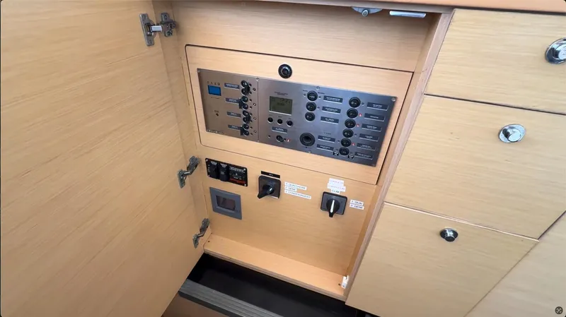 Ivana V Yacht Photos Pics Control panel inside a 2012 Lagoon 450 yacht, featuring switches and dials.