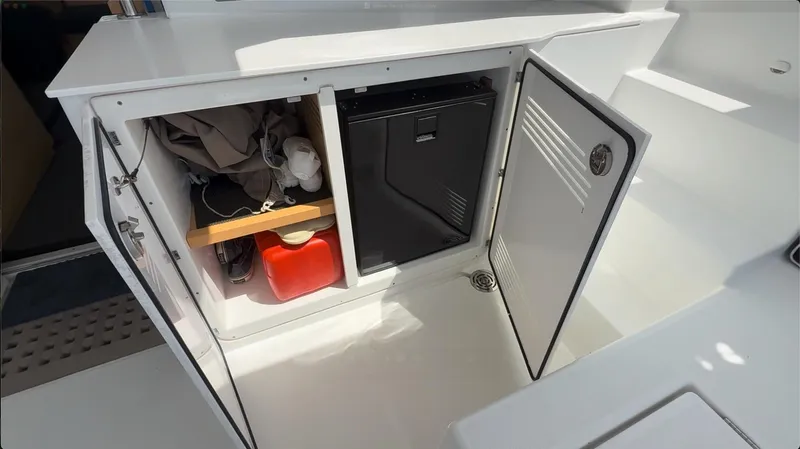 Ivana V Yacht Photos Pics Open storage compartment on a 2012 Lagoon 450 yacht, showing equipment and supplies.