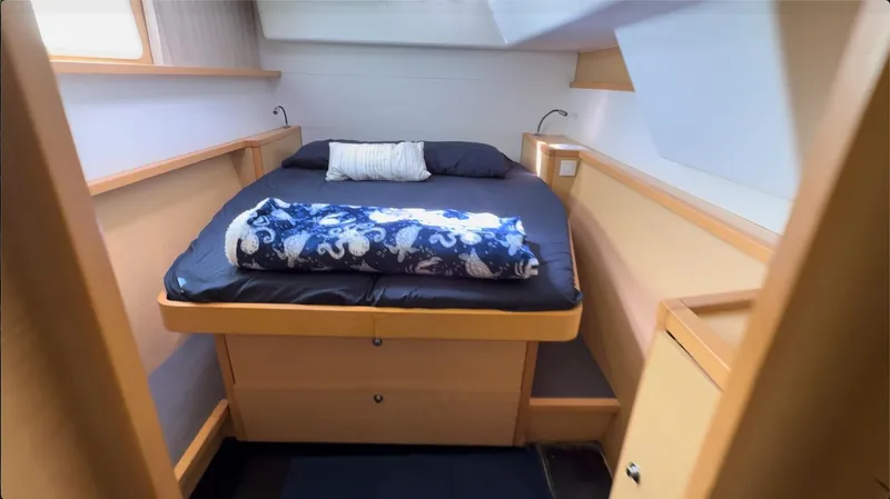 Ivana V Yacht Photos Pics Cozy bedroom in 2012 Lagoon 450 yacht with modern furnishings and nautical decor.