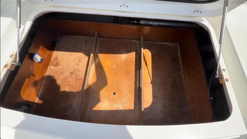 Ivana V Yacht Photos Pics Open storage compartment on a 2012 Lagoon 450 catamaran, featuring wooden dividers.