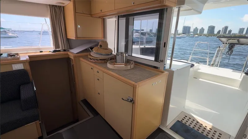 Ivana V Yacht Photos Pics Interior of 2012 Lagoon 450 yacht with city skyline view through window.