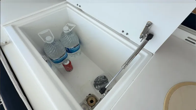 Ivana V Yacht Photos Pics Open storage compartment on 2012 Lagoon 450 yacht with water bottles and a soda can.