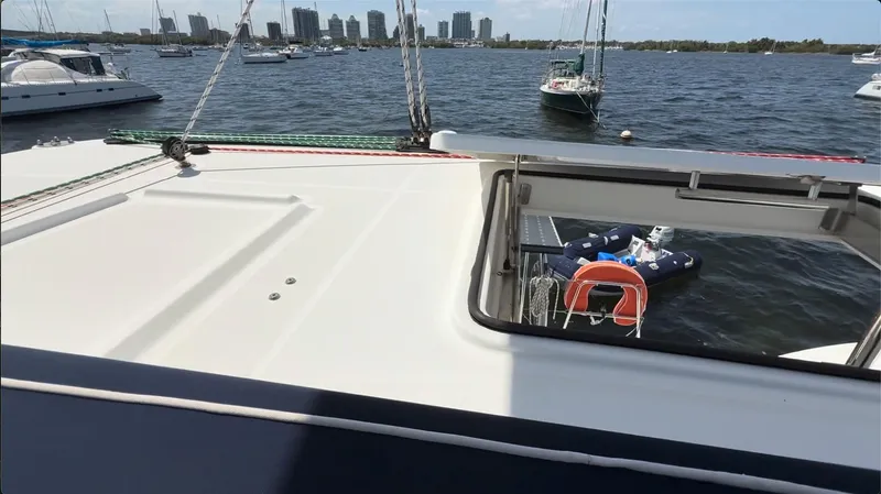 Ivana V Yacht Photos Pics Catamaran Lagoon 450 (2012) on water with city skyline in background.