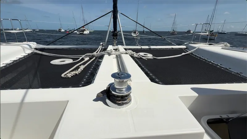 Ivana V Yacht Photos Pics Catamaran deck view, Lagoon 450, 2012 model, with ropes and winch, anchored in calm waters.