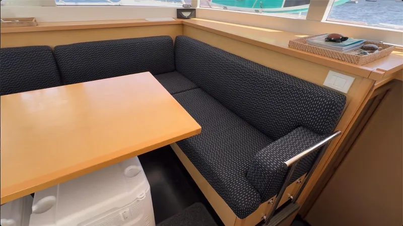 Ivana V Yacht Photos Pics Interior of 2012 Lagoon 450 yacht with cozy seating and wooden table.