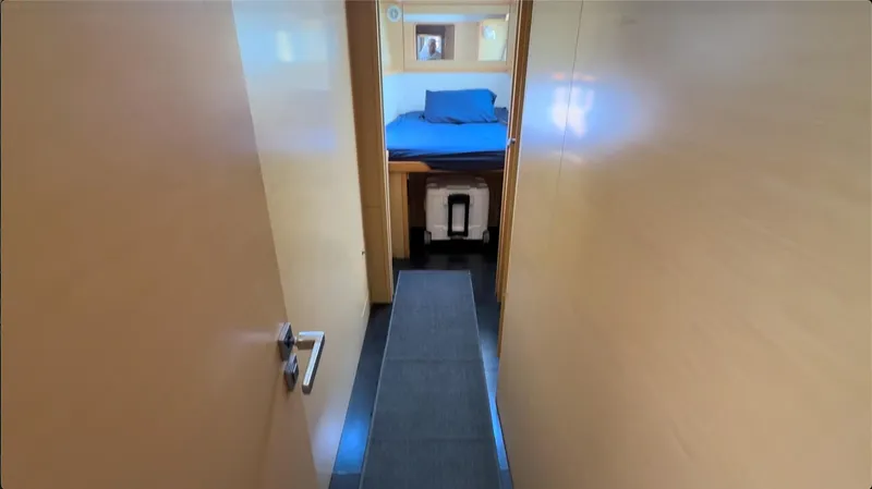 Ivana V Yacht Photos Pics Interior view of a 2012 Lagoon 450 yacht cabin with bed and wooden walls.