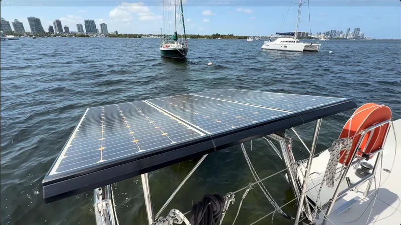 Ivana V Yacht Photos Pics Catamaran Lagoon 450 (2012) with solar panels on deck, anchored in a scenic bay.