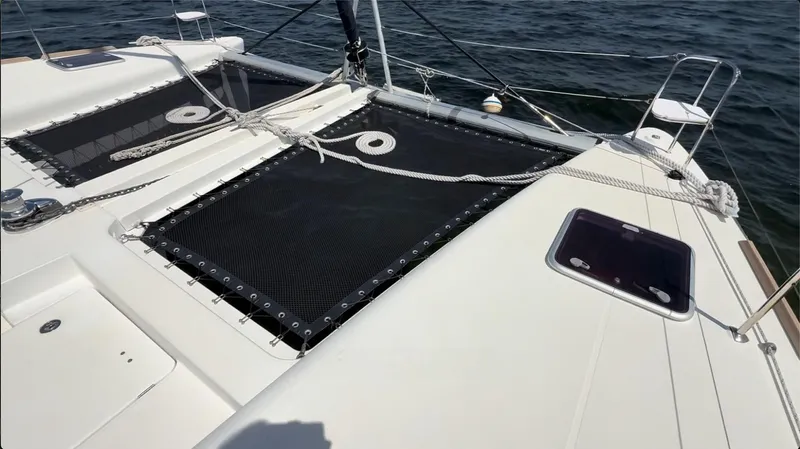 Ivana V Yacht Photos Pics 2012 Lagoon 450 catamaran deck with netting and ocean view.