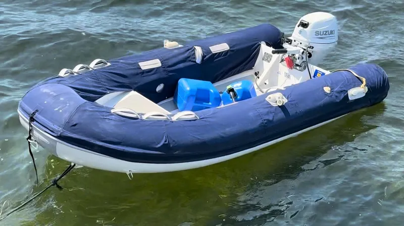 Ivana V Yacht Photos Pics Inflatable boat with Suzuki motor on water, Lagoon 450, 2012 model.