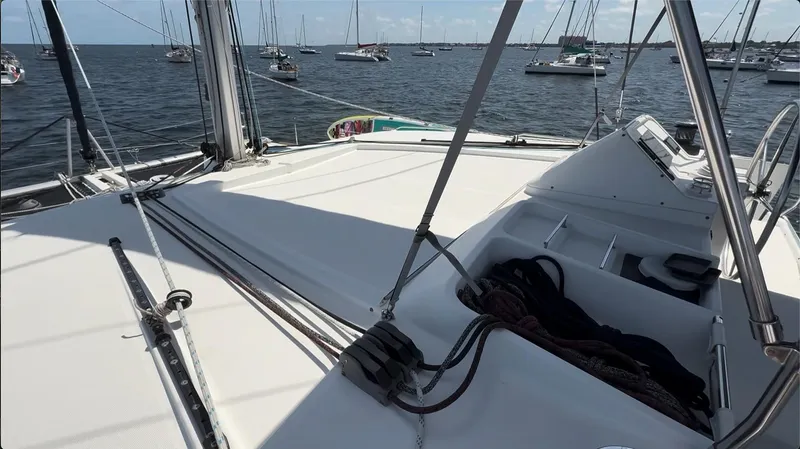 Ivana V Yacht Photos Pics Deck view of a 2012 Lagoon 450 catamaran with ropes and ocean backdrop.