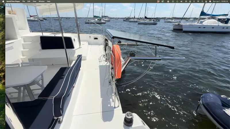 Ivana V Yacht Photos Pics Lagoon 450 catamaran deck, 2012 model, docked with lifebuoy and seating area.