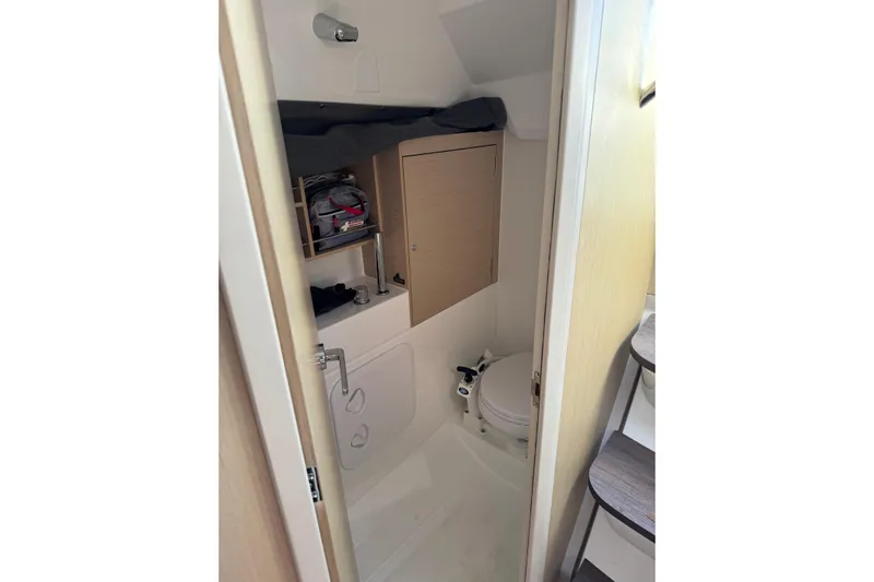 Kaifu Yacht Photos Pics Compact bathroom in a 2020 Beneteau Oceanis 30.1 sailboat, featuring modern fixtures and storage.