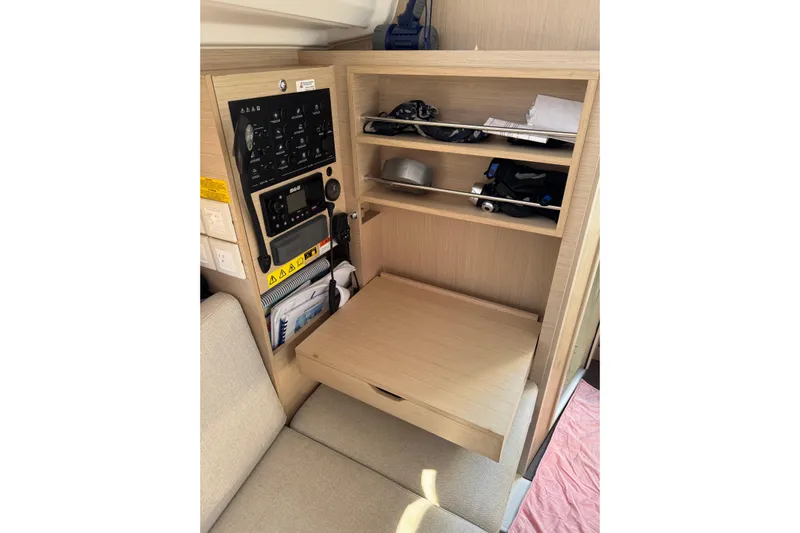 Kaifu Yacht Photos Pics Beneteau Oceanis 30.1 interior navigation station with control panel and storage shelves.