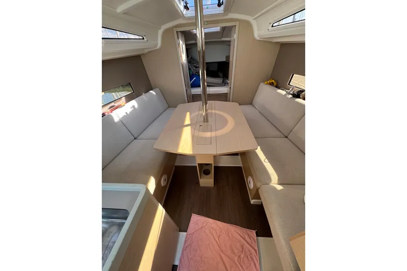 Kaifu Yacht Photos Pics Interior of 2020 Beneteau Oceanis 30.1 sailboat with cozy seating and table.