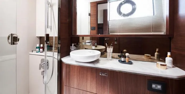  Yacht Photos Pics Luxurious bathroom in 2025 Princess S62 yacht with modern fixtures and elegant wood finishes.