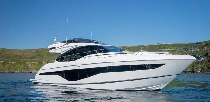  Yacht Photos Pics 2025 Princess S62 yacht cruising on a sunny day, showcasing sleek design and luxury features.