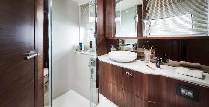  Yacht Photos Pics Luxurious bathroom in 2025 Princess S62 yacht with modern fixtures and wooden cabinetry.