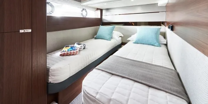  Yacht Photos Pics Luxurious twin cabin in 2025 Princess S62 yacht with modern decor and plush bedding.