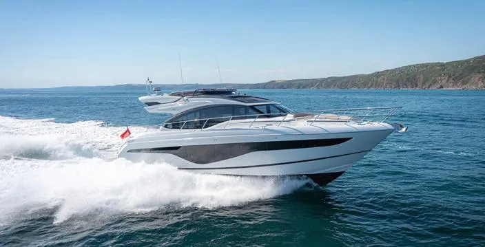  Yacht Photos Pics 2025 Princess S62 yacht cruising on open sea under clear blue sky.