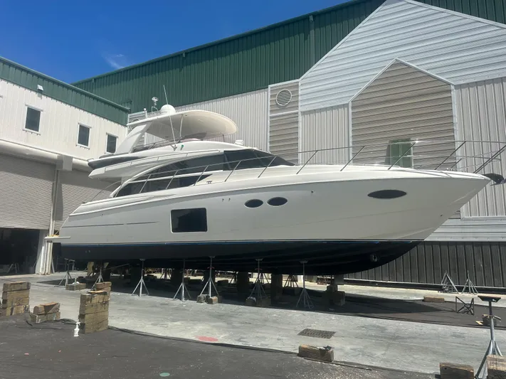  Yacht Photos Pics 2015 Princess F56 yacht in dry dock, surrounded by industrial buildings.