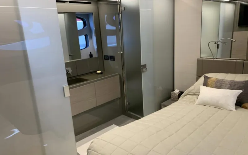  Yacht Photos Pics Luxurious interior of 2020 Pershing 62 yacht featuring a modern bedroom and bathroom.
