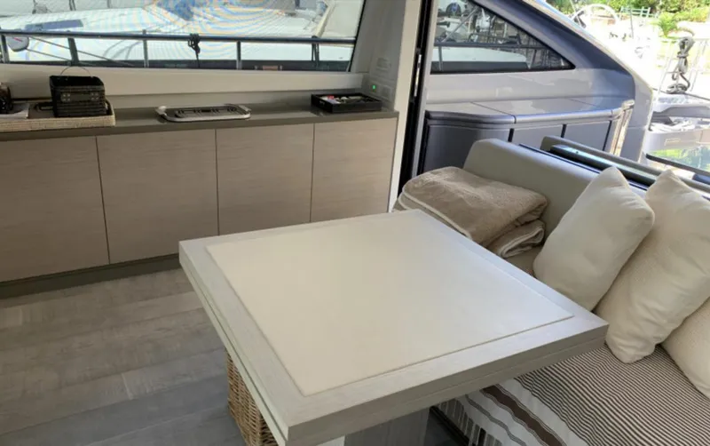  Yacht Photos Pics Interior of 2020 Pershing 62 yacht with modern seating and table setup.