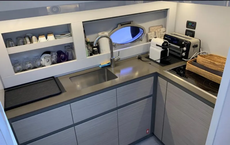  Yacht Photos Pics Modern kitchen in a 2020 Pershing 62 yacht with sleek cabinetry and appliances.