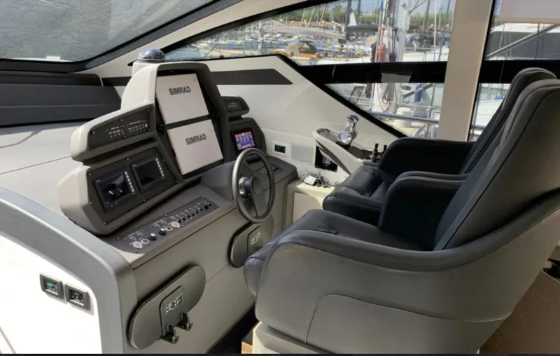  Yacht Photos Pics Cockpit of 2020 Pershing 62 yacht with modern navigation equipment and luxurious seating.