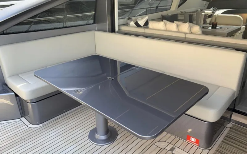  Yacht Photos Pics Luxurious seating area on a 2020 Pershing 62 yacht with sleek table design.