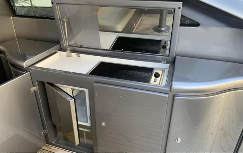  Yacht Photos Pics Modern kitchen area on a 2020 Pershing 62 yacht, featuring sleek cabinetry and appliances.