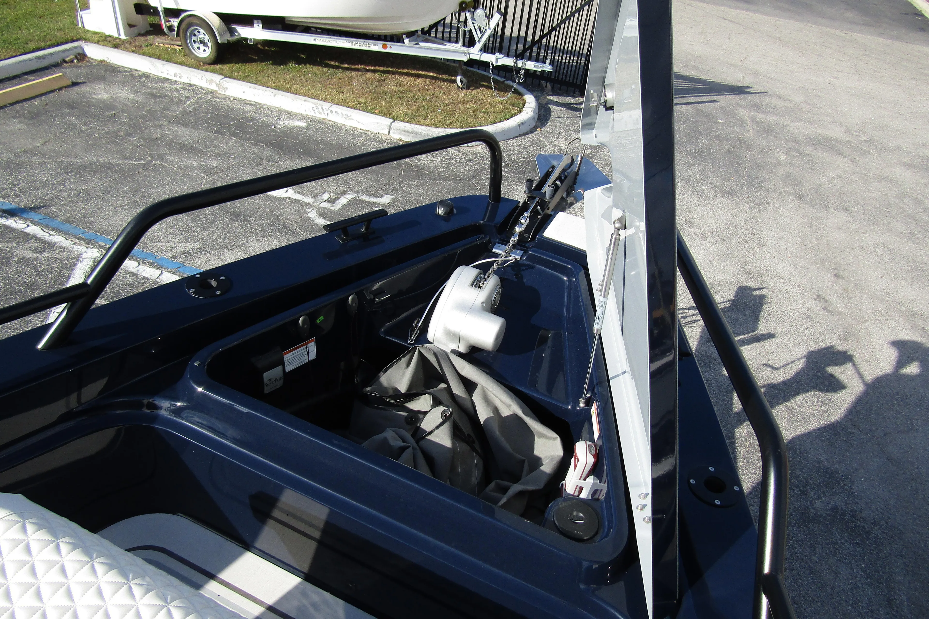 2024 BRABUS Shadow 900 ST boat storage compartment with open hatch, docked near trailer.