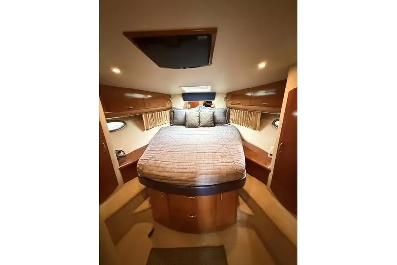  Yacht Photos Pics Luxurious cabin interior of 2005 Carver 36 Mariner yacht with cozy bed and wood finish.