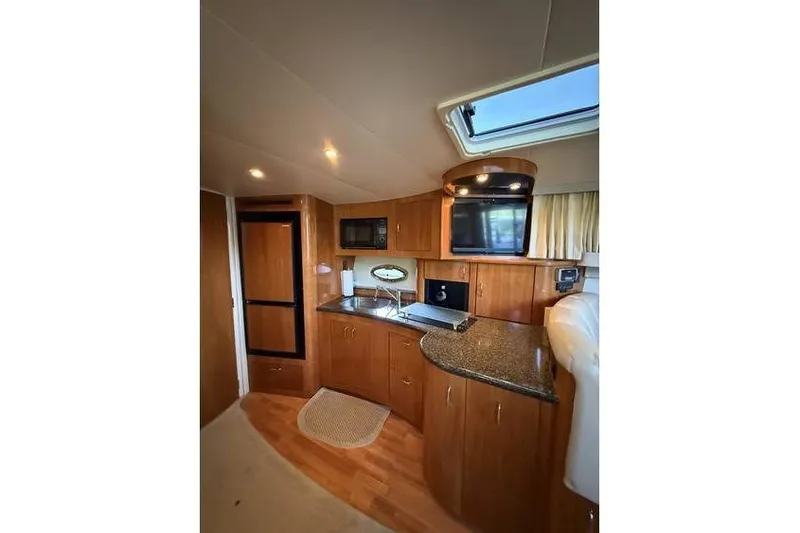  Yacht Photos Pics Luxurious interior of 2005 Carver 36 Mariner yacht with modern kitchen amenities.