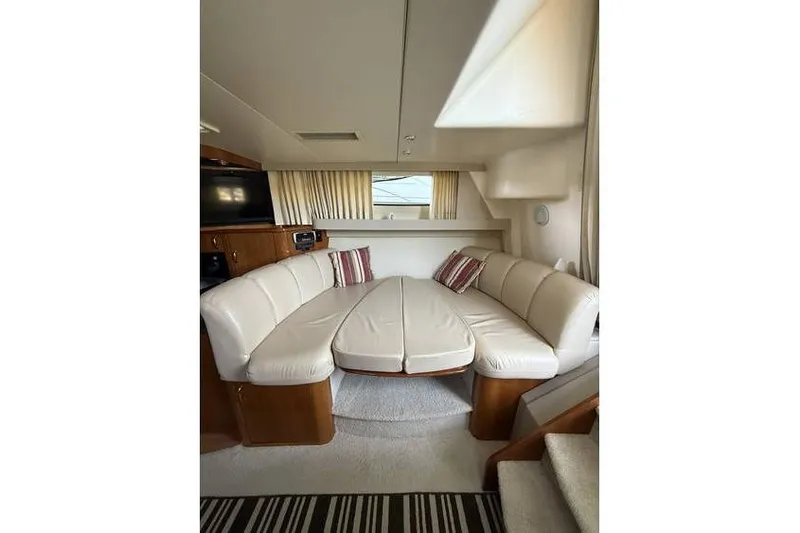 Yacht Photos Pics Interior of 2005 Carver 36 Mariner yacht with plush seating and striped cushions.