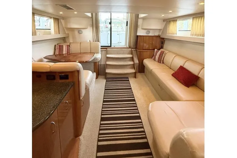  Yacht Photos Pics Luxurious interior of 2005 Carver 36 Mariner yacht with plush seating and elegant decor.
