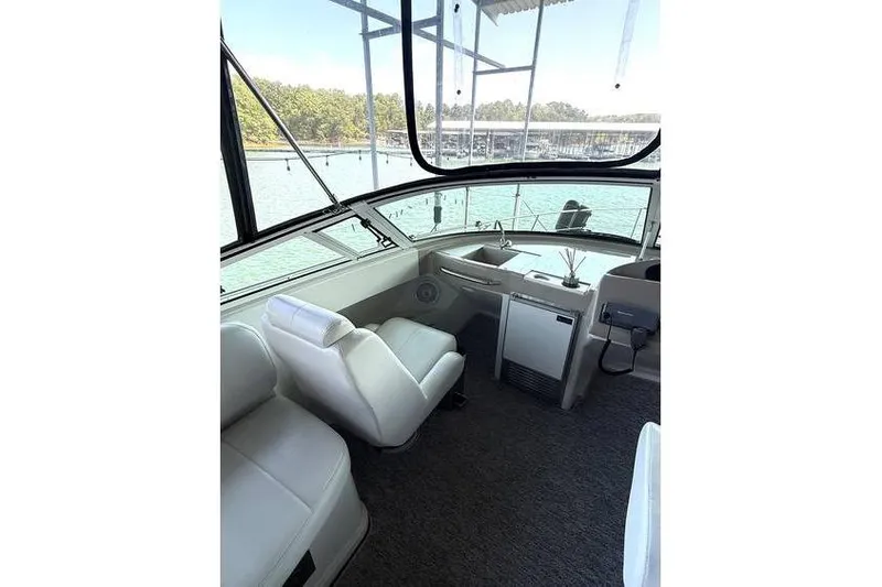  Yacht Photos Pics 2005 Carver 36 Mariner interior with white seating and lake view.