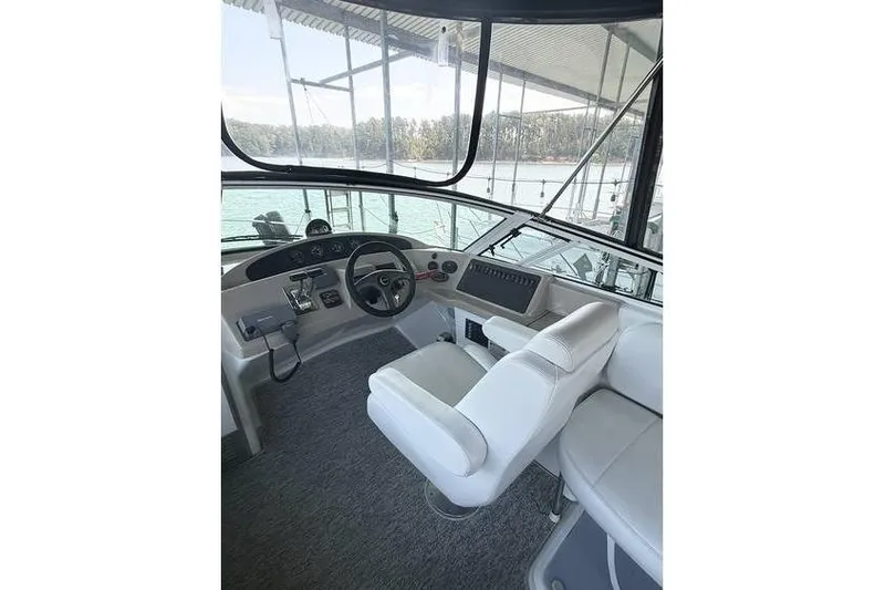 Yacht Photos Pics 2005 Carver 36 Mariner helm with steering wheel and controls, docked by the water.