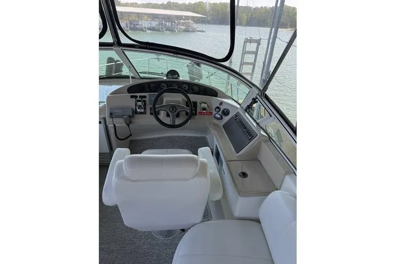  Yacht Photos Pics 2005 Carver 36 Mariner helm with steering wheel, controls, and white captain's chair.