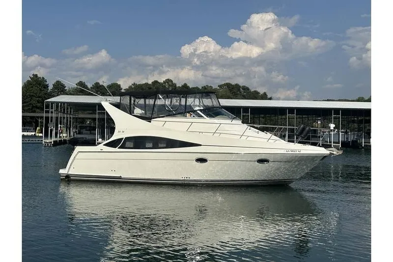  Yacht Photos Pics 2005 Carver 36 Mariner yacht docked on calm water under a blue sky.